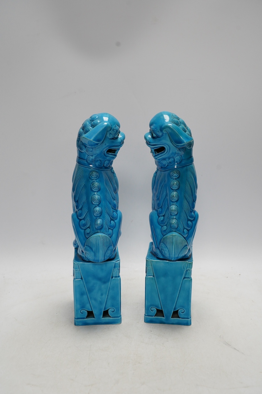 A pair of Chinese turquoise glazed lion dogs, 29cm. Condition - good